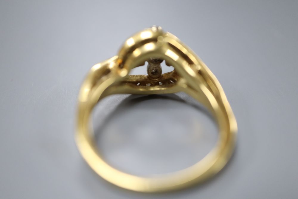 An 18ct yellow gold and diamond ring of scroll design, size O, gross 6 grams.